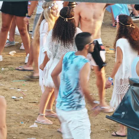 group of friends having fun and dancing on the beach