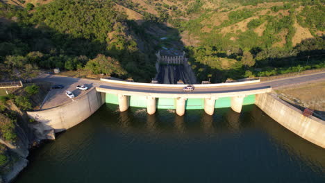 driving car on dam bridge of reservoir lake in tropical landscape of dominican republic