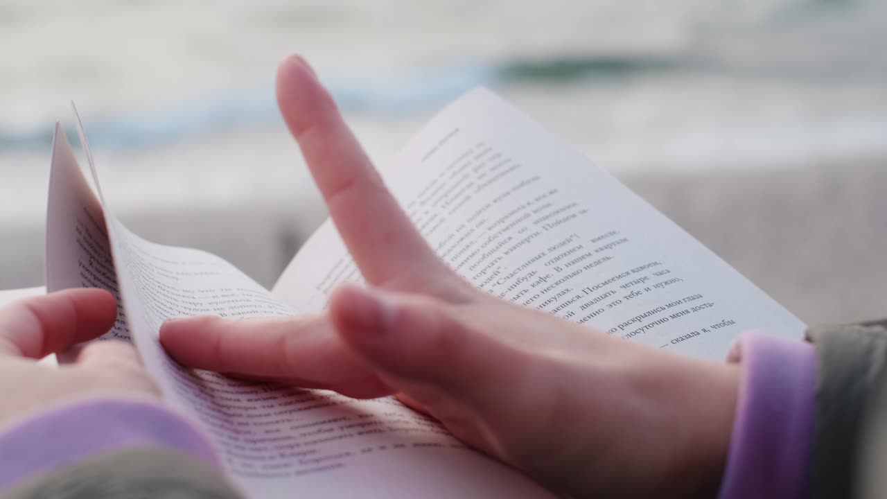 Person Reading a Book on the Beach