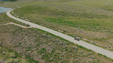 aerial of a truck driving down a rural road