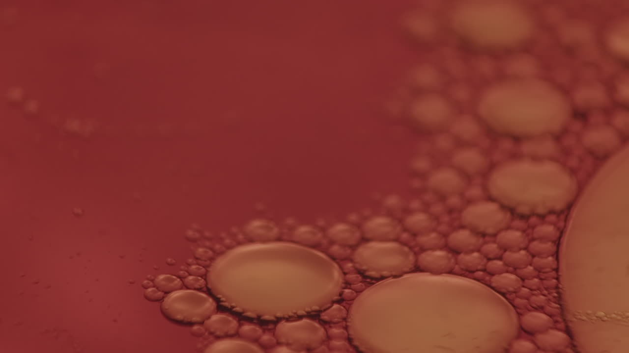 primer plano macro de pequeñas burbujas moviéndose en la superficie roja