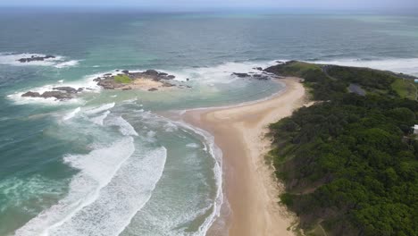 long golden sand seashore overlooking bonville headland at sawtell beach in pacific ocean, nsw, australia