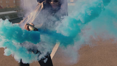 dancing woman waving blue smoke grenade in city street hip hop dancer girl celebrating creative freedom with dance slow motion