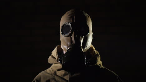 a man in a protective suit and gas mask smoke in the foreground