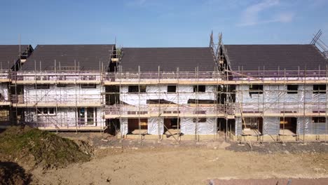 casas que se están construyendo con andamios y materiales de aislamiento de lámina