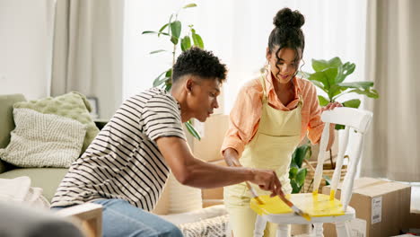couple painting a chair during home renovation