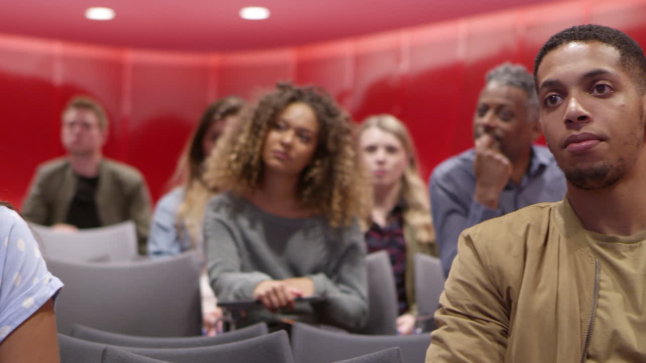 University students sitting in a lesson, close up front view, shot on R3D