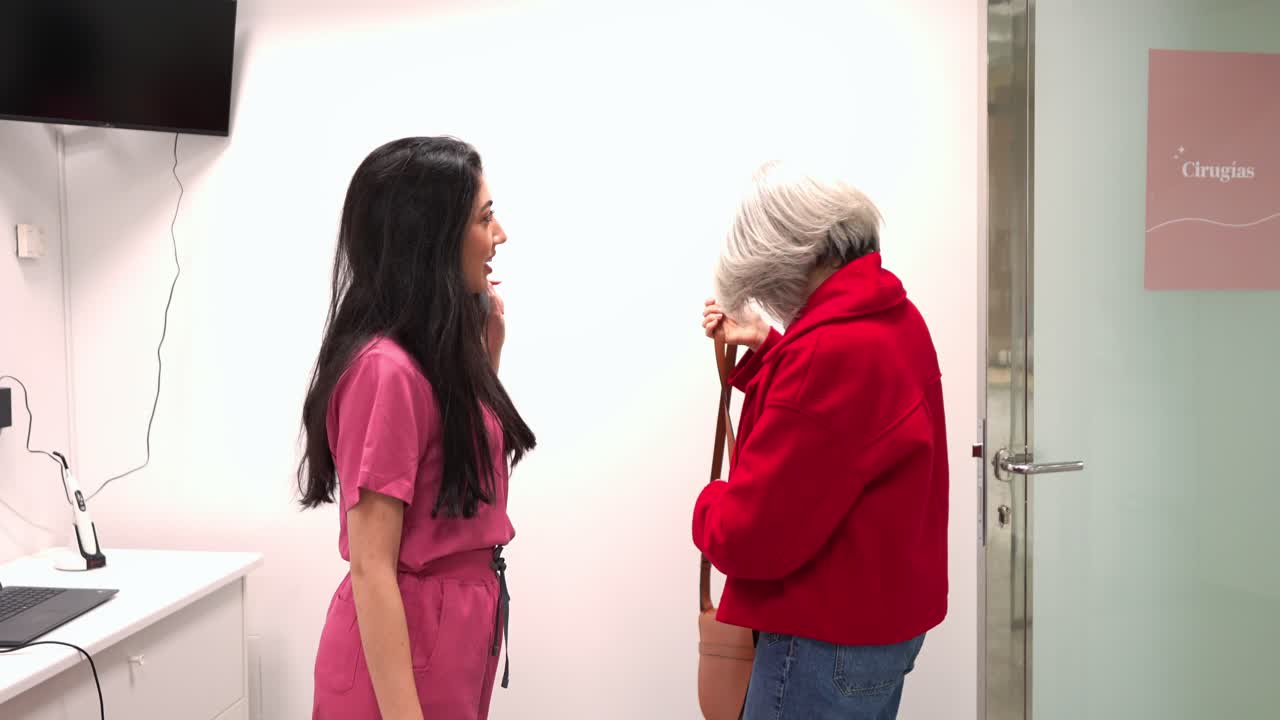 Female Doctor and Senior Patient Entering Medical Room