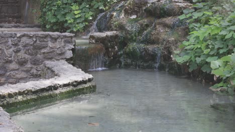 hot water spring flowing and falling into a pool