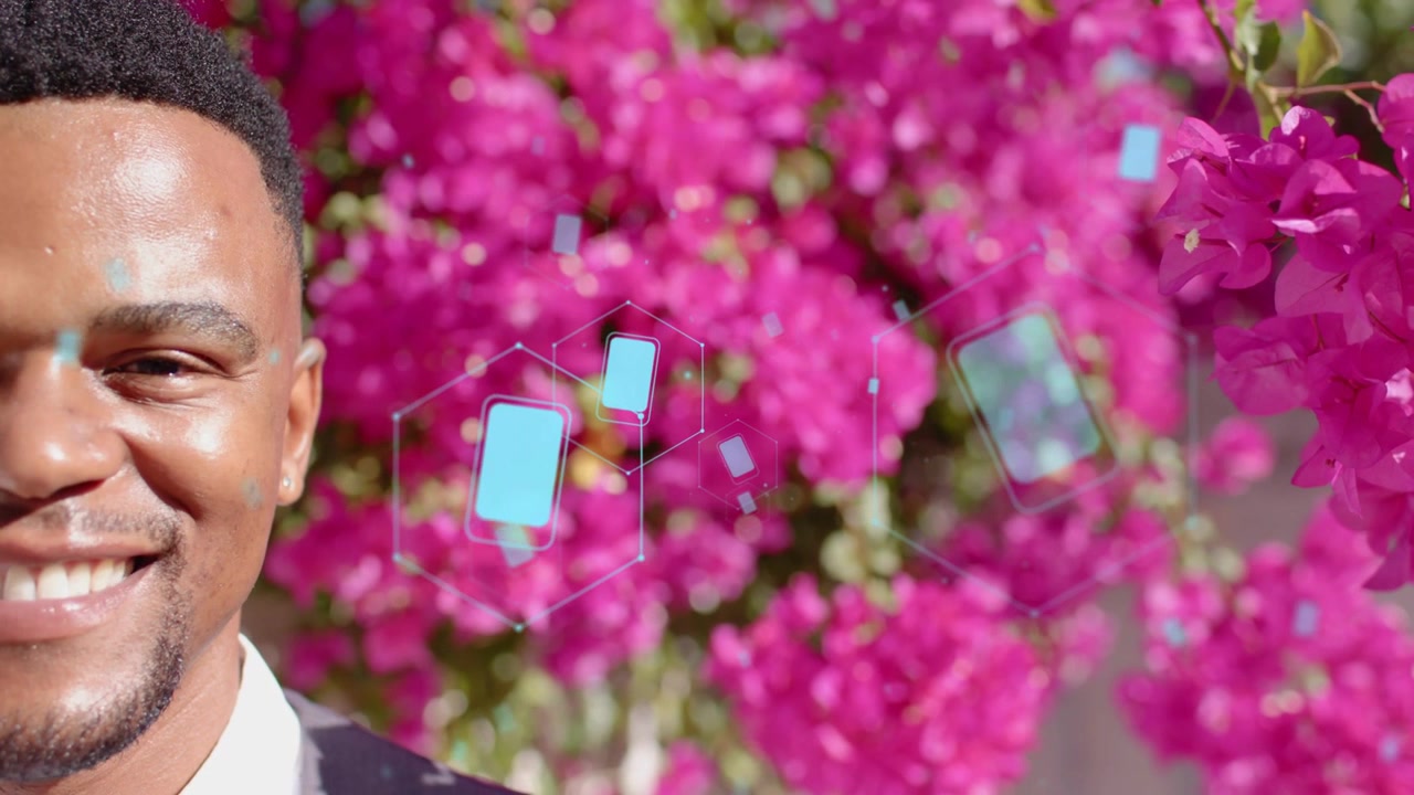 Mand til venstre reagerer og smiler til cyan sekskantede ikoner, der driver over ansigtet mod bougainvillea, til et promo-portræt.
