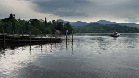 the view of derwentwater with boat from the ferry landing at keswick in cumbria, england, united kingdom