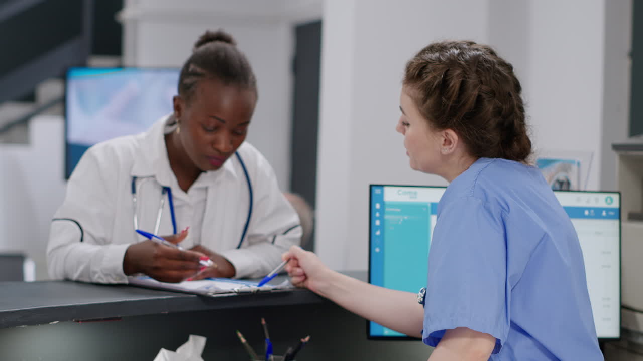 Medical staff working at reception desk in hospital