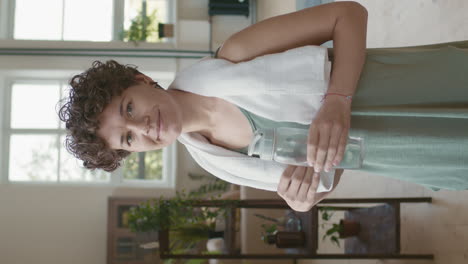 woman taking a break and drinking water after exercise