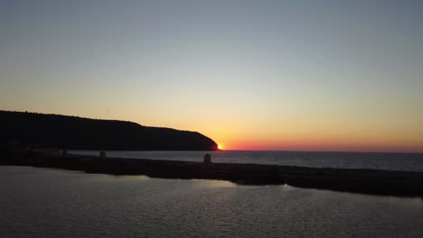 Lefkada---Aerial-shot-of-sunset-over-sea-horizon