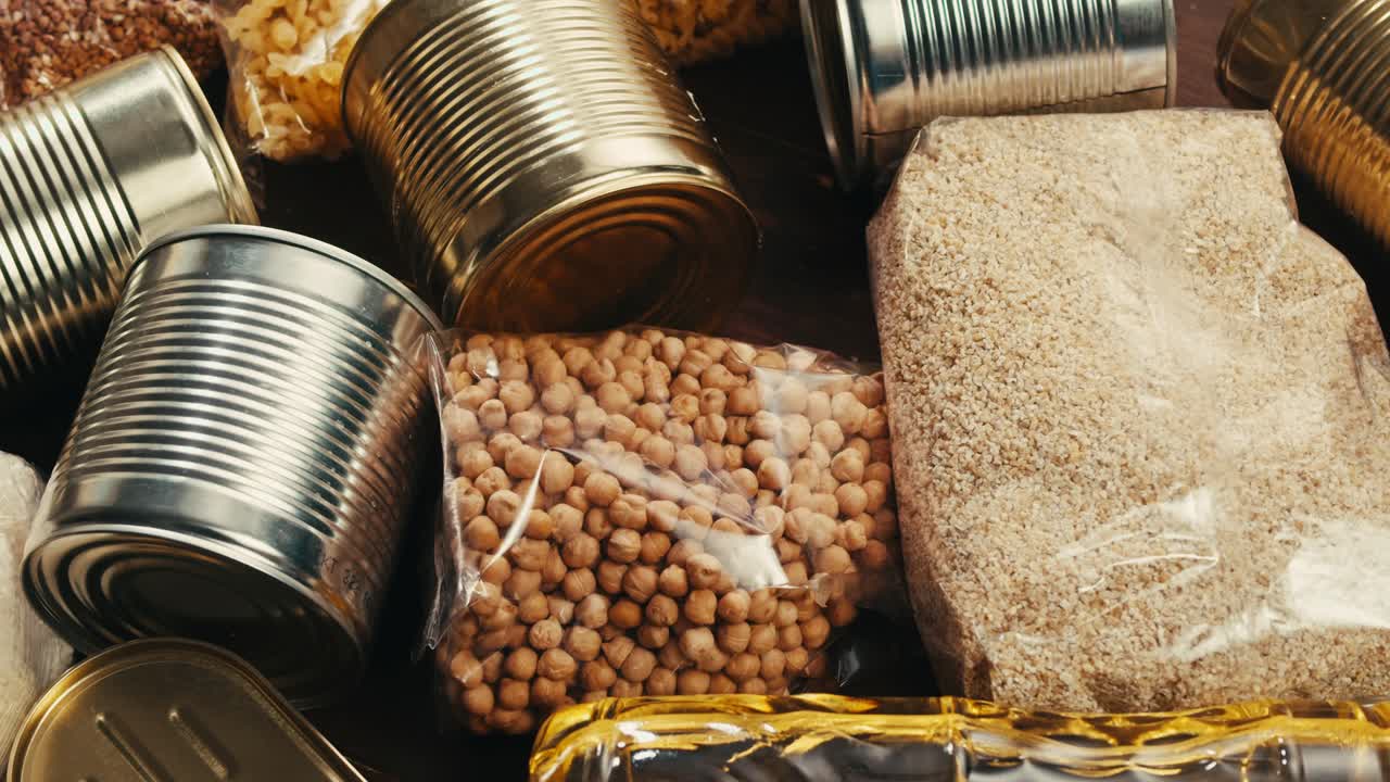 Canned cereals beans fish and vegetables, an assortment of processed foods, supermarket cart online shopping, delivery.