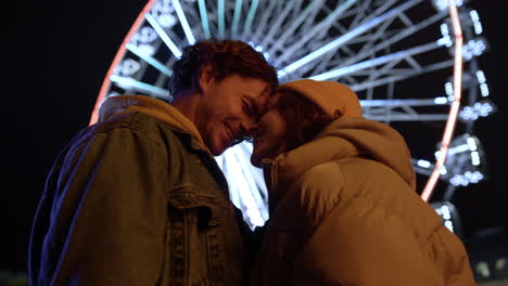 love couple laughing in city center. man and woman kissing on urban street.