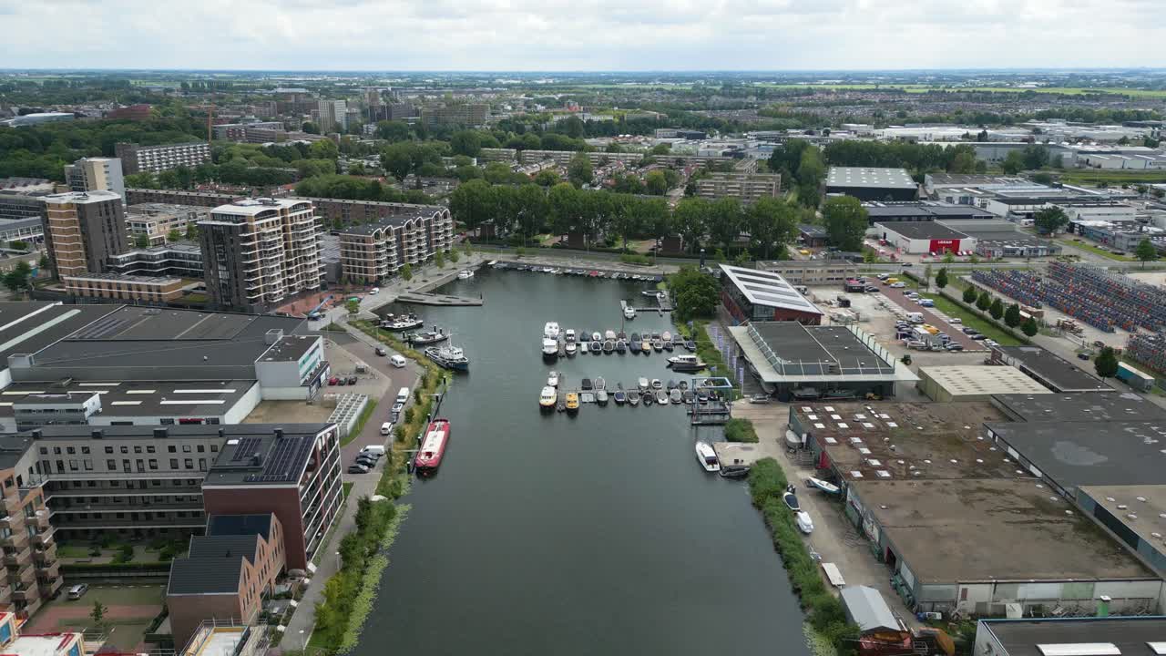 Drone overview of a Dutch urban marina, showing new waterfront apartments and boats docked in Alphen aan den Rijn