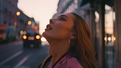 carefree girl enjoying urban evening standing street closeup. model posing town
