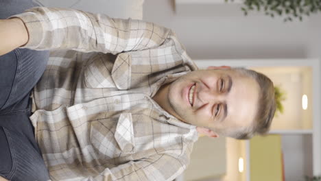 Vertical-video-of-Positive-man-happy-and-smiling.