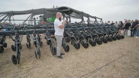 demonstration of agricultural machinery at an exhibition. tractors operate in the field, showcasing their capabilities and performance in action