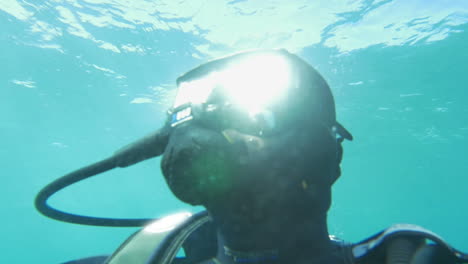 scuba diver in blue water on sunny day