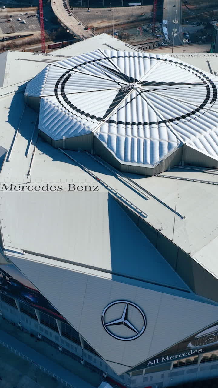 Atlanta, Georgia, USA - January 02, 2024: Aerial top view of the roof of Mercedes Benz Stadium. Close-up. Fly around the building. Vertical video