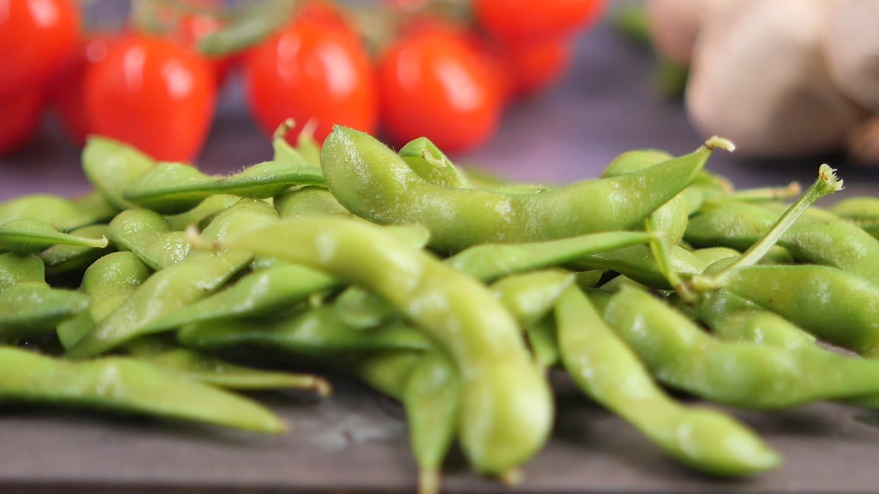 Fresh Green Edamame Pods Falling in Slow Motion
