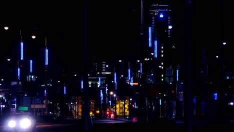 night view of a city street with blue lights