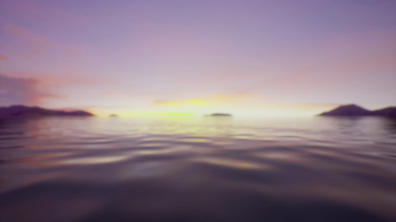 Sunset over calm ocean waters with distant islands and soft clouds