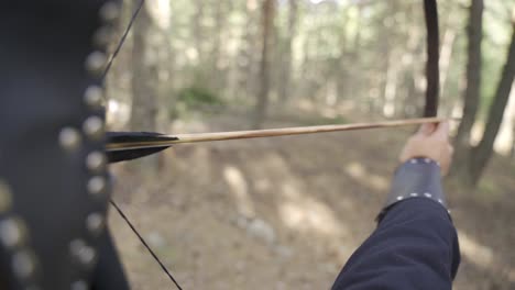 shooting arrows in historical war gear.