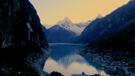 Huaraz-Park,-Peru,-snowy-peak-in-front-of-the-lake-at-sunshine