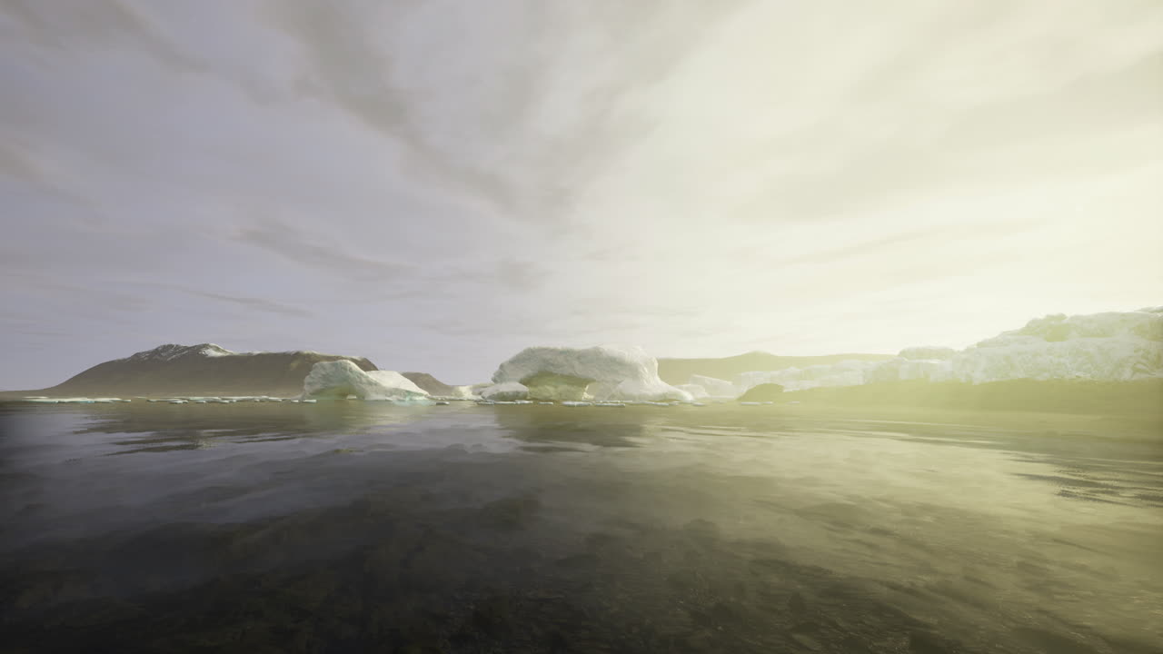 Beautiful sunrise over calm waters with icebergs in the distance