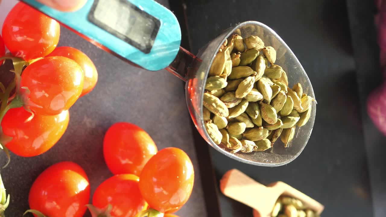 Measuring Cardamom with Kitchen Scale and Cherry Tomatoes