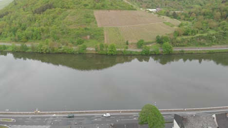 Picturesque-aerial-view-of-a-Mosel-valley-town-in-Germany,-tilt-up-reveals-river