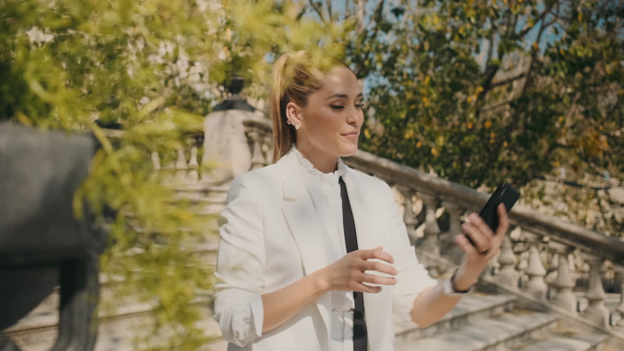 Stylish young woman taking selfie outdoors.