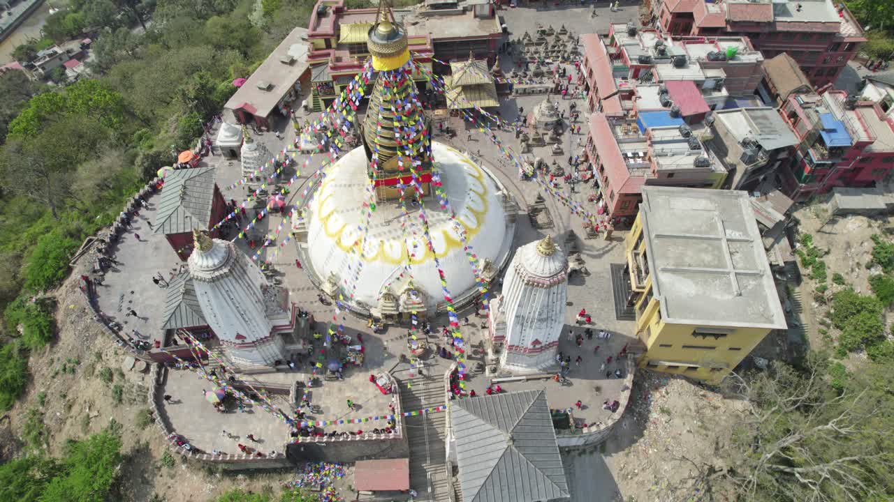 Drone footage capturing Swayambhunath Stupa atop the hill, with Kathmandu City sprawling below. The video shows sacred architecture, urban energy, and the valley’s scenic beauty from above