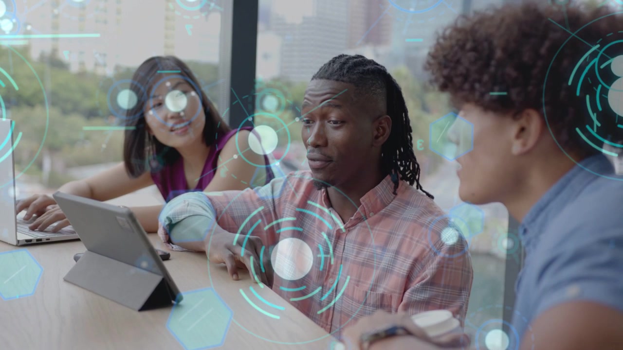 Three coworkers leaning in, central person pointing tablet and activating teal tech HUD overlay