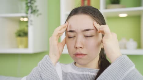 asian young woman with severe headache has migraine.