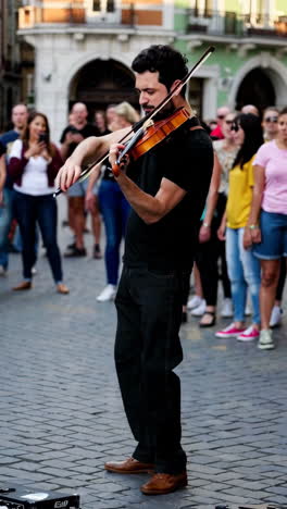 violinist performing on a city street