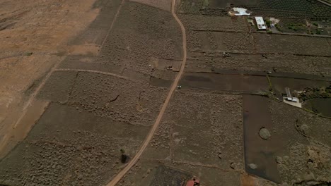 road in volcanic terrain. aerial overhead view. dirt road in desert area of   volcanic lava. canary islands. spain.