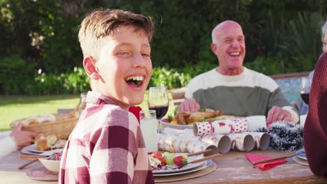 Portrait-of-happy-caucasian-family-having-dinner-in-garden