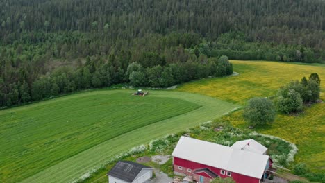 Aerial-View-Of-Agricultural-Field-With-Working-Tractor-In-The-Countryside---drone-shot
