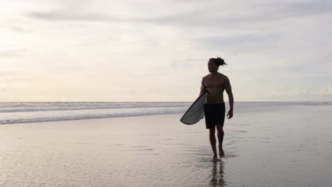 young man with surfboard