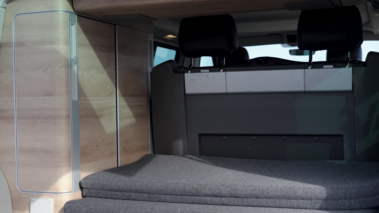 slow establishing shot of car seats inside the back of a travel van