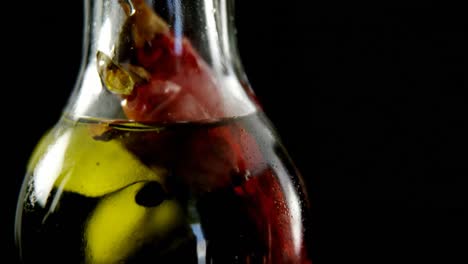 bottles of olive oil with dried red chili pepper 4k