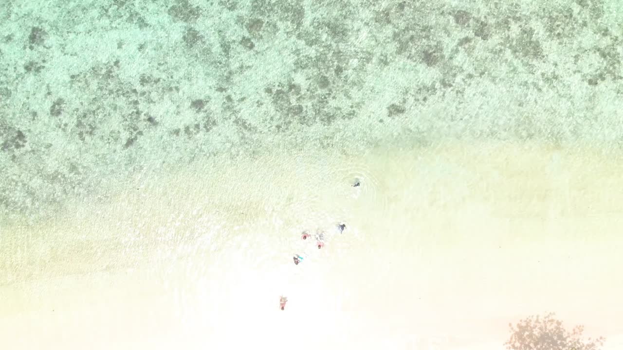 Aerial tilt up drone shot above a white sand beach, revealing the turquoise ocean, at Coron island, in Philippines, Asia