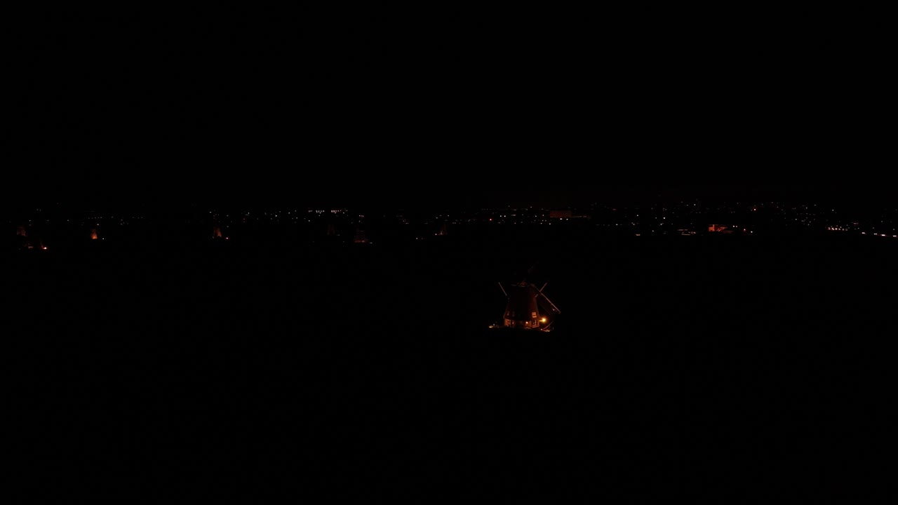 In the dead of night the lights of an isolated windmill illuminates it&rsquo;s surroundings