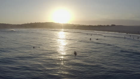 sunset beach scene with surfers