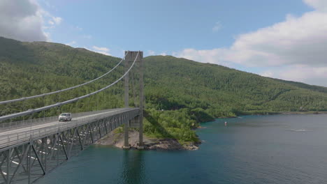 close up aerial view of steel suspension bridge with vehicles crossing, skjomen