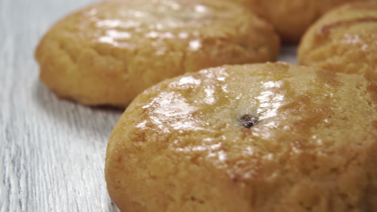 Appetizing butter cookies spinning on a wooden board